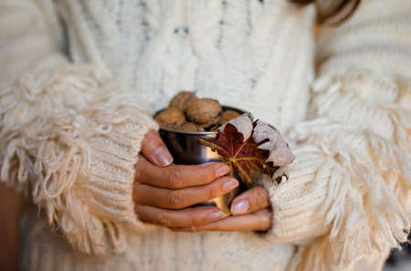 Detail of woman's hands, holding a handful of organic walnuts. Selective focusの写真素材