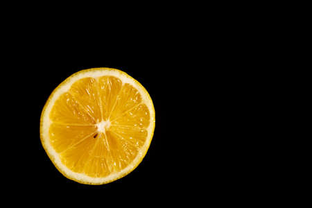 lemon slice isolated on black backgroundの写真素材