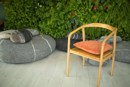 A seating area at the front desk of a modern house, comfortable sofas and green plantsの写真素材