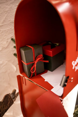 Red mailbox with gift boxes and greeting cards.