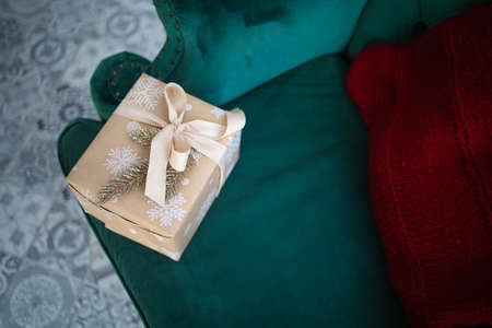 The gift box lies on the blue couchの写真素材