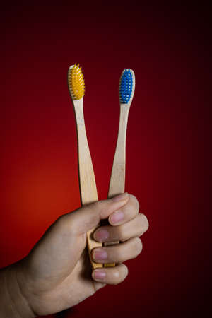 Wooden toothbrush isolated on a red backgroundの写真素材