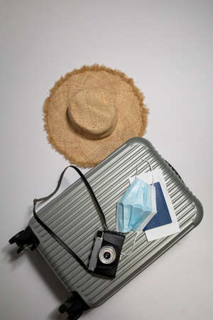 Travel suitcase or luggage, passport, air ticket and mask. Travel ban during the pandemic of coronavirus or covid-19の写真素材