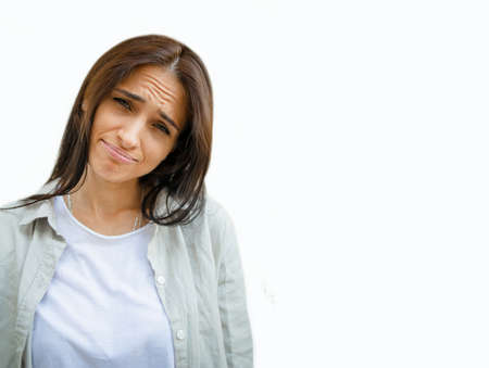 Close-up portrait of nice attractive lovely lovable pretty cute charming girlish funny unsure brown-haired girl looking at camera isolated on white background.の写真素材