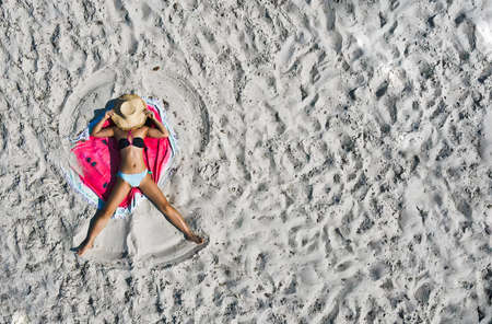 defaultTop Aerial Drone View Of young woman traveler tourist In Swimsuit Bikini Relaxing And...