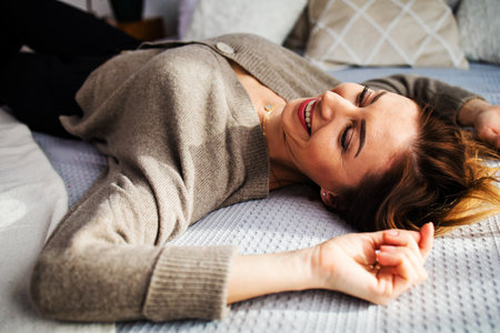 attractive middle aged woman relaxing at homeの写真素材