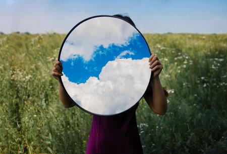 Sky reflection in mirror on spring field