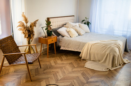 White pillows on a wooden bed in a minimal bedroom interior with plants and bedside table. real photoの写真素材