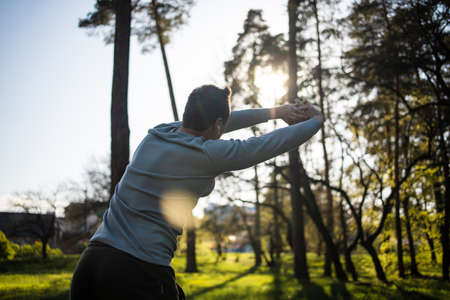 Young man jogging exercise healthy lifestyle in park at sunsetの写真素材