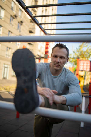 A man is engaged in sports outside on the playground, fitness, sport, lifestyle.