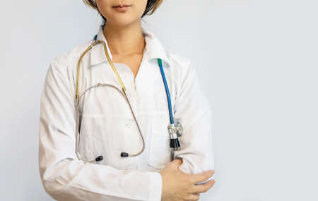 Portrait of smiling asian doctor looking at camera. Happy pediatrician standing on white background...
