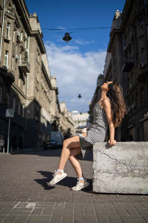 Young trendy asian woman having fun while walking outdoor in europe center city of Ukraine.の写真素材