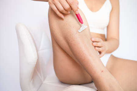 Hygiene skin body care concept. hair removal. Closeup woman shaving legs with razor blade. After...