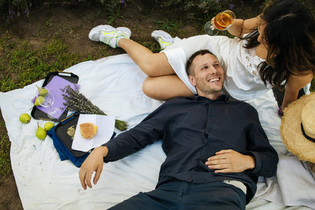 Couple on romantic picnic with french baguette in lavender field. vacation and travel concept.の写真素材
