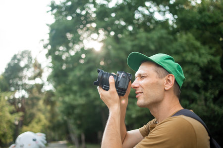 Photographer taking picture with professional camera outdoors
