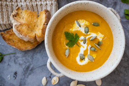 Vegetarian autumn pumpkin cream soup with seeds