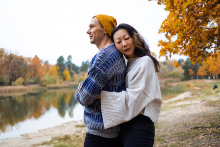 A couple of lovers run through the autumn park and have wonderful moments of happiness and joy. love and tenderness. lifestyle concept.の写真素材
