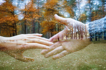 Young couple in love walking in autumn park holding hands close-up.の写真素材