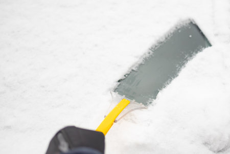 Clearing and remove snow from windshield, Scraping ice. Winter season car window cleaning. Copy space for your text.の写真素材