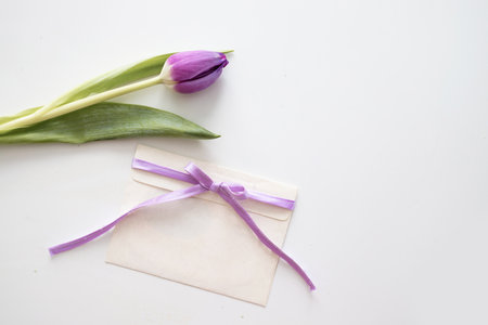 greeting card mockup. bouquet of purple tulips isolated on a white background. space for text. invitation. congratulations.の写真素材