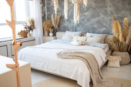 White bedroom interior with dry flowers, trendy loft design and white lines on double bedの写真素材