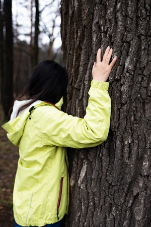 Young asian woman hugging a big tree, love nature concept.の写真素材
