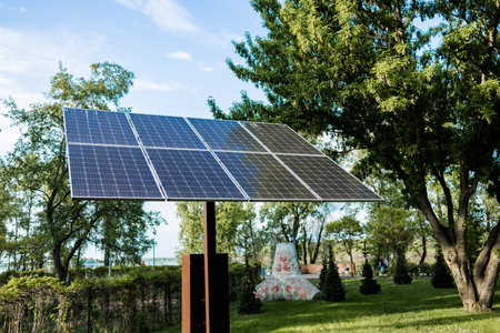 Solar panels in public park in Ukraine. Photovoltaic modules for renewable energy, system of...