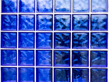 Old wall made of blue glass blocks. Glass blocks background.の写真素材