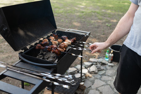 Grill the pork. close-up of some meat skewers grilled on a bbq. Grilled food in the backyard of the house.の写真素材