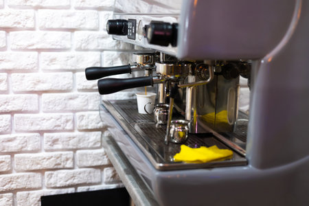 Professional coffee brewing. Espresso machine preparing and pouring two perfect cups of coffee. Restaurant detailsの写真素材