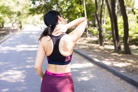 Athletic young woman stretching before jogging in the parkの写真素材