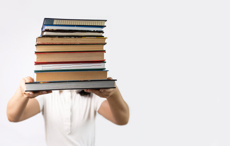 Woman holding a stack of books on white background. education concept.