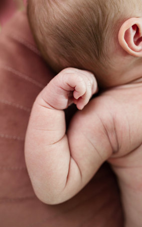 Newborn baby nursing in bed, skin to skin, soft skin , baby hand natural background.の写真素材