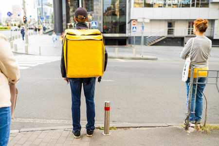 Pizza delivery, boy with thermal bag delivering food on city street. Food dlivery service, man...