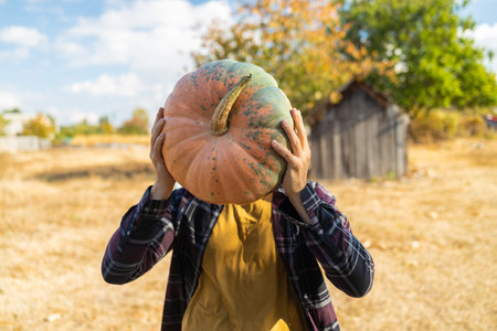 Portrait of a man with a pumpkin instead of a head. Autumn image.の写真素材