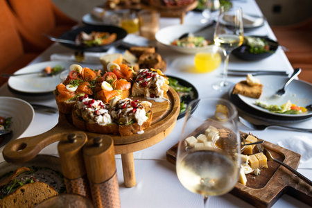 catering wedding buffet with variety of food snacks and wine glassesの写真素材