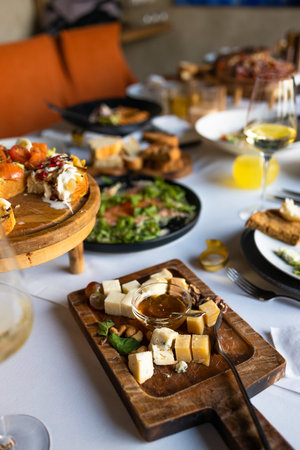 catering food on the table in a restaurant with white wineの写真素材