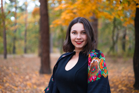 Portrait of a beautiful young woman in an autumn park. Beauty, fashion.