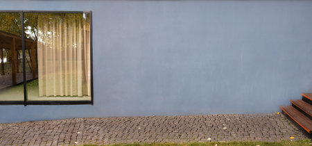 Facade of a modern house with a blue wall. Nobody inside
