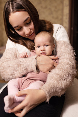 Portrait of a young mother with her little daughter at home.
