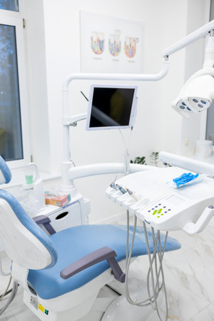 Interior of a modern dental office with dentists chair and equipmentの写真素材