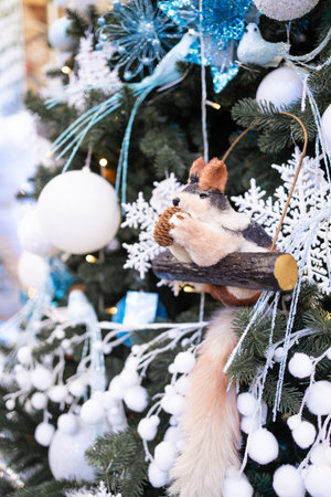 Christmas tree decorated with toys in the form of squirrels and snowflakesの写真素材