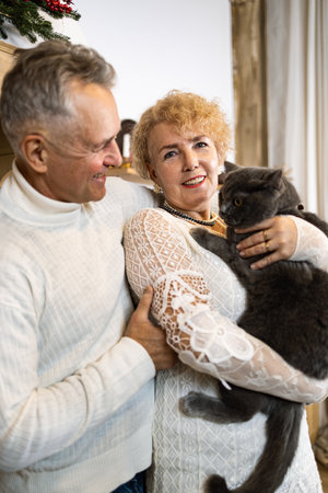Senior couple stroking a cat as a pet for companionship and against loneliness.の写真素材
