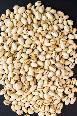 Pistachios on a black background. Healthy food concept.