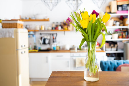 Fresh bouquet of tulips on a kitchen table. Mothers Day. March 8, International Women's Day.の写真素材