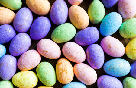 Colorful easter eggs on a wooden background, top view.