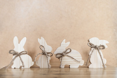 Easter decoration with wooden bunnies on rustic background with copy spaceの写真素材