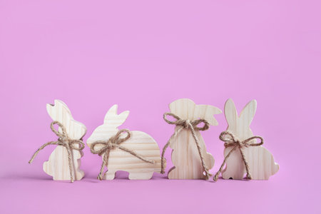 Easter toys. Wooden rabbit isolated on pink background. copy space.