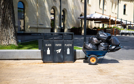 Garbage trolley with garbage bags in the city. Recycling conceptの写真素材