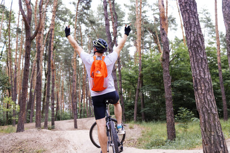 Cyclist Riding the Bike on the Trail in the Forest. Extreme Sport Concept.の写真素材